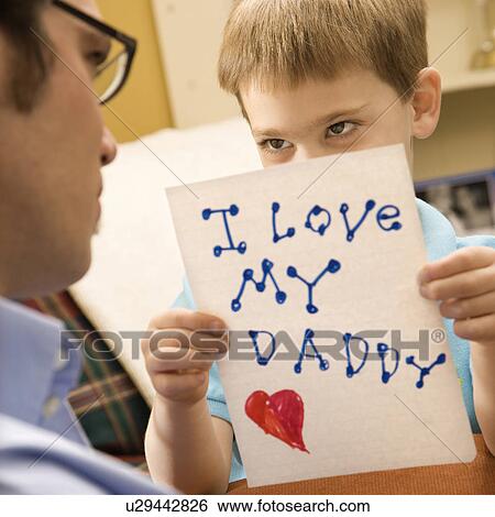 Caucasian boy giving mid adult father a drawing. View Large Photo Image Stock Photograph - Caucasian boy giving mid adult father a drawing.. Fotosearch