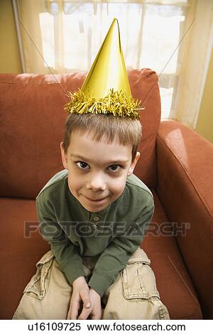 Caucasian boy with party hat looking at viewer and making facial expression. View Large Photo Image Stock Photography - Caucasian boy with party hat looking at viewer and making facial expression.. Fotosearch