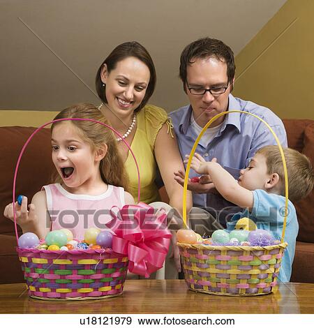 Stock Photo - Caucasian family with looking at Easter baskets.. Fotosearch