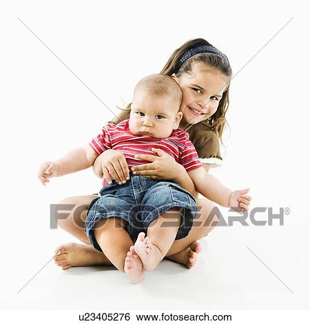 Cute little girl holding baby brother in her lap View Large Photo Image Stock Photograph - Cute little girl holding baby brother in her lap. Fotosearch