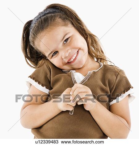 Stock Image - Cute little girl standing and smiling at viewer. Fotosearch