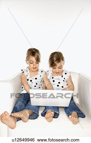 Female children Caucasian twins playing with laptop computer. View Large Photo Image Stock Photograph - Female children Caucasian twins playing with laptop computer.. Fotosearch