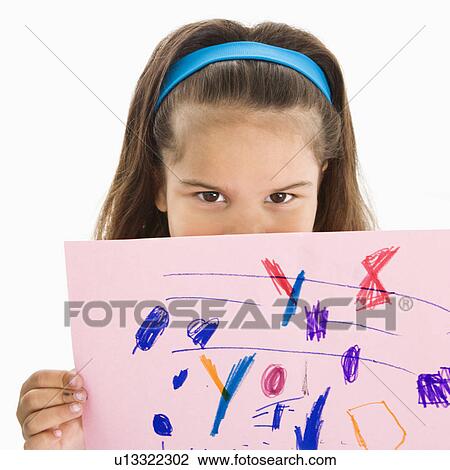 Stock Image - Girl holding drawing over mouth. Fotosearch