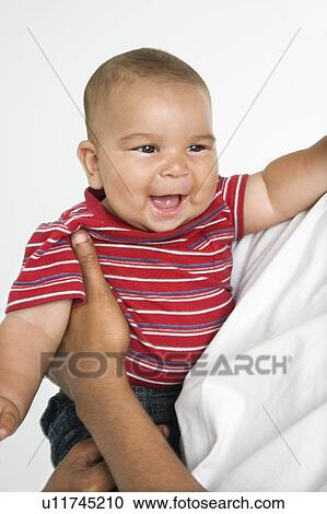 Stock Image - Man holding little baby. Fotosearch