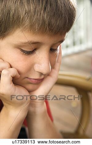 Portrait of Caucasian pre-teen boy with chin in hands looking down. View Large Photo Image Stock Image - Portrait of Caucasian pre-teen boy with chin in hands looking down.. Fotosearch