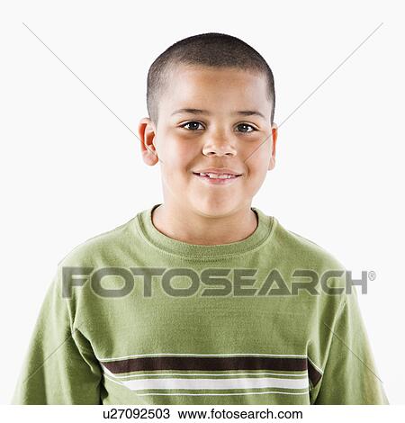 Stock Image - Young latino adolescent boy standing smiling at viewer.. Fotosearch