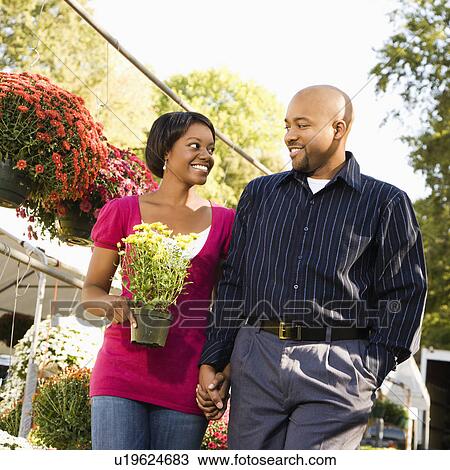 Stock Image - Couple picking out flowers. Fotosearch