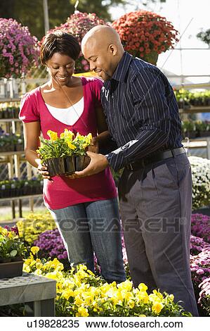 Stock Photography - Couple picking out flowers. Fotosearch