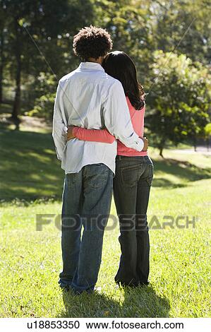 Stock Image - Couple standing in park . Fotosearch