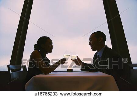 Couple toasting wine glasses View Large Photo Image Stock Image - Couple toasting wine glasses. Fotosearch