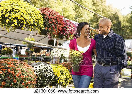 Happy couple picking out flowers View Large Photo Image Stock Photo - Happy couple picking out flowers. Fotosearch
