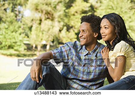 Stock Image - Smiling couple in park. Fotosearch