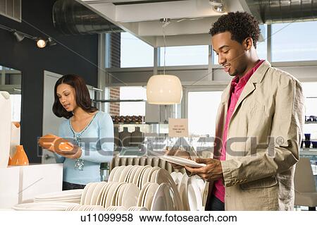 Stock Photo - Couple shopping in a home furnishings retail store. Fotosearch