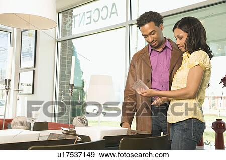 Couple shopping in retail store View Large Photo Image Stock Photo - Couple shopping in retail store. Fotosearch