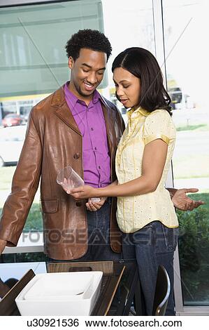 Stock Photograph - Couple shopping in retail store. Fotosearch