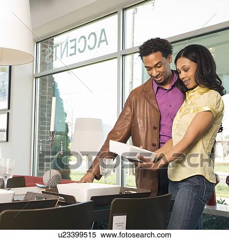 Stock Photography - Couple shopping in retail store. Fotosearch