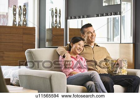 Couple watching television. View Large Photo Image Picture - Couple watching television.. Fotosearch