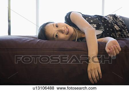 Stock Photo - Female lying on bed. Fotosearch