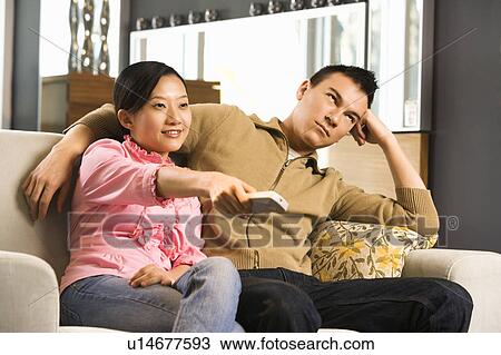 Female pointing remote while male looks annoyed View Large Photo Image Stock Image - Female pointing remote while male looks annoyed. Fotosearch