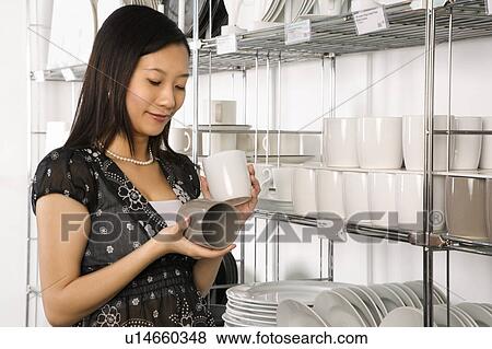 Female shopping for dishes and glasses View Large Photo Image Stock Photo - Female shopping for dishes and glasses . Fotosearch