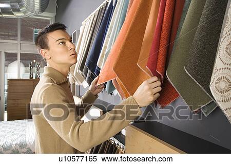 Male looking at fabric swatches in retail store View Large Photo Image Stock Photography - Male looking at fabric swatches in retail store. Fotosearch