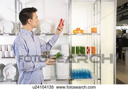 Stock Photography - Man shopping for dishes and glasses . Fotosearch