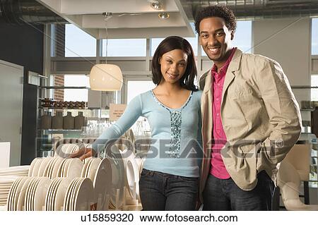 Portrait of young couple in home furnishings retail store View Large Photo Image Stock Image - Portrait of young couple in home furnishings retail store. Fotosearch