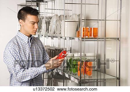 Stock Image - Shopping for dishes and glasses in a store. Fotosearch