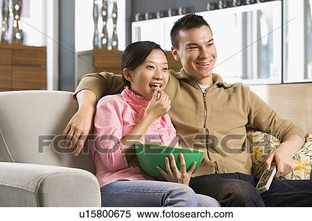 Stock Photography - Watching television. Fotosearch