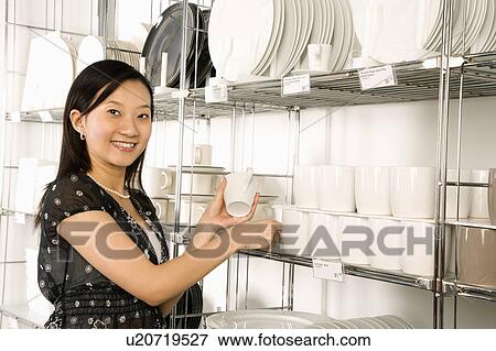Woman shopping for dishes and glasses View Large Photo Image Stock Photo - Woman shopping for dishes and glasses . Fotosearch