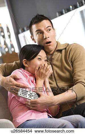 Picture - Woman with scared expression while man comforts her. Fotosearch