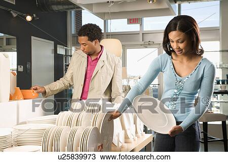 Stock Image - Young couple shopping in a home furnishings retail store. Fotosearch