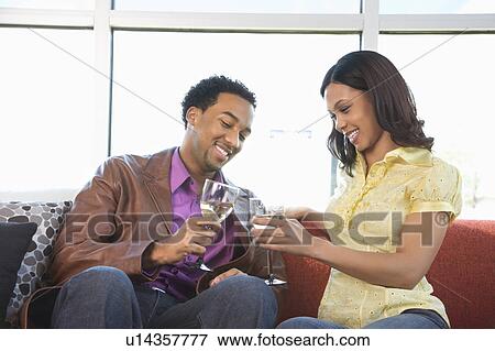 Young couple toasting with wine glasses. View Large Photo Image Stock Photo - Young couple toasting with wine glasses.. Fotosearch