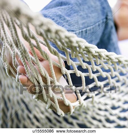 Stock Photograph - Close up of young adult woman's feet in hammock.. Fotosearch