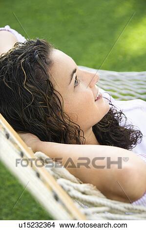 Picture - Lying in hammock smiling. Fotosearch