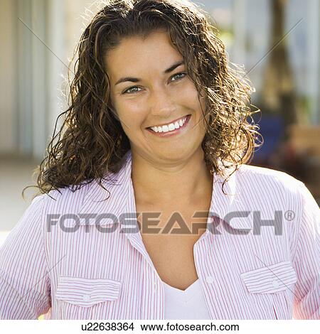 Portrait of pretty young adult brunette woman smiling and looking at viewer. View Large Photo Image Picture - Portrait of pretty young adult brunette woman smiling and looking at viewer.. Fotosearch
