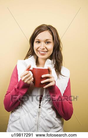 Woman holding coffee cup and smiling View Large Photo Image Stock Image - Woman holding coffee cup and smiling . Fotosearch