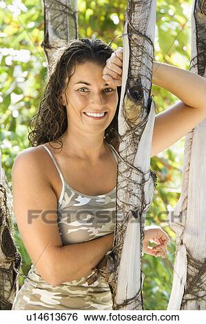 Woman leaning against tree View Large Photo Image Stock Photograph - Woman leaning against tree . Fotosearch