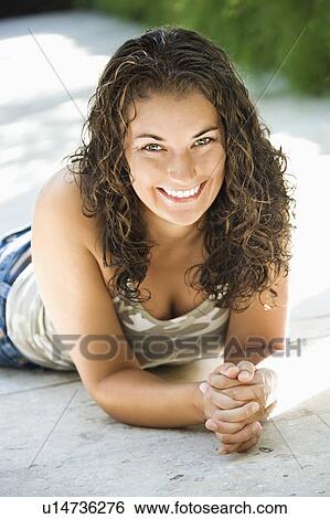 Stock Photograph - Woman lying on walkway . Fotosearch