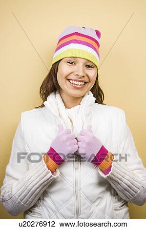 Stock Image - Woman wearing winter hat and gloves . Fotosearch