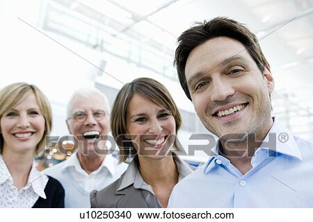 Stock Image - 4 happy people looking at viewer. Fotosearch