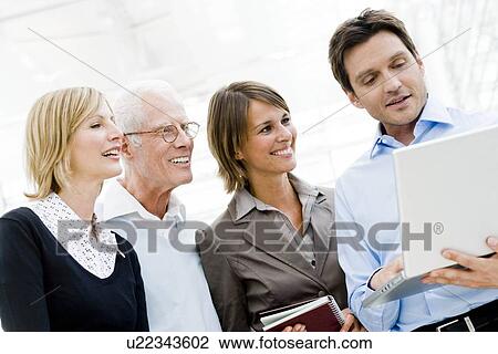 4 people looking at laptop View Large Photo Image Stock Image - 4 people looking at laptop. Fotosearch
