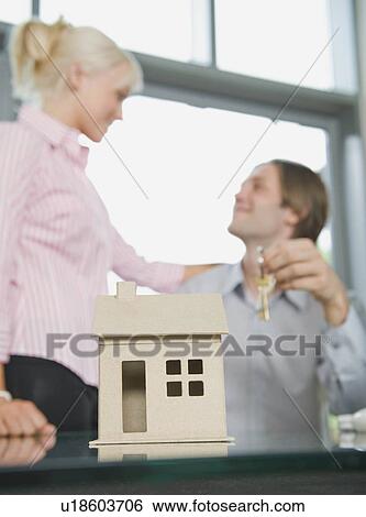 A couple holding the keys to their home View Large Photo Image Stock Photograph - A couple holding the keys to their home. Fotosearch