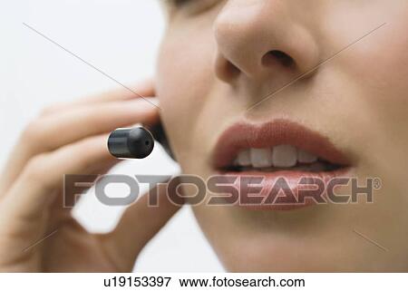 A woman wearing a headset View Large Photo Image Stock Photo - A woman wearing a headset. Fotosearch