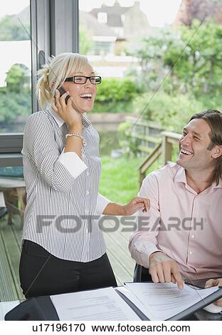 Couple conduct business over the phone View Large Photo Image Stock Image - Couple conduct business over the phone. Fotosearch