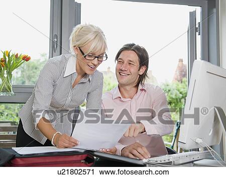 Stock Image - Couple discussing a letter. Fotosearch