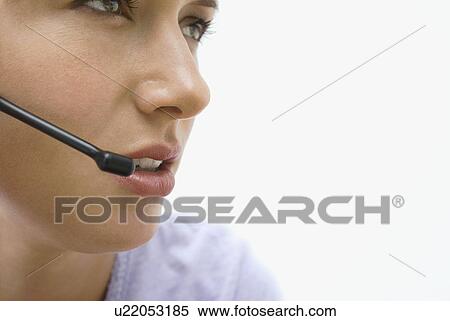 Crop of a woman on a headset View Large Photo Image Stock Photography - Crop of a woman on a headset. Fotosearch