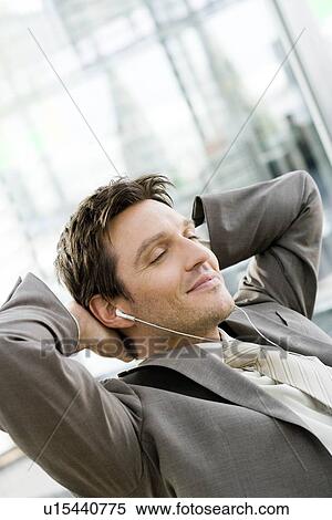 Stock Photography - Man listening wearing headphones. Fotosearch