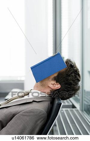 Man sleeping with book on his face View Large Photo Image Stock Photograph - Man sleeping with book on his face. Fotosearch