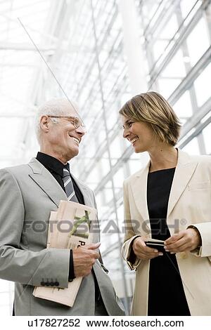 Older man talking to younger woman View Large Photo Image Stock Image - Older man talking to younger woman. Fotosearch